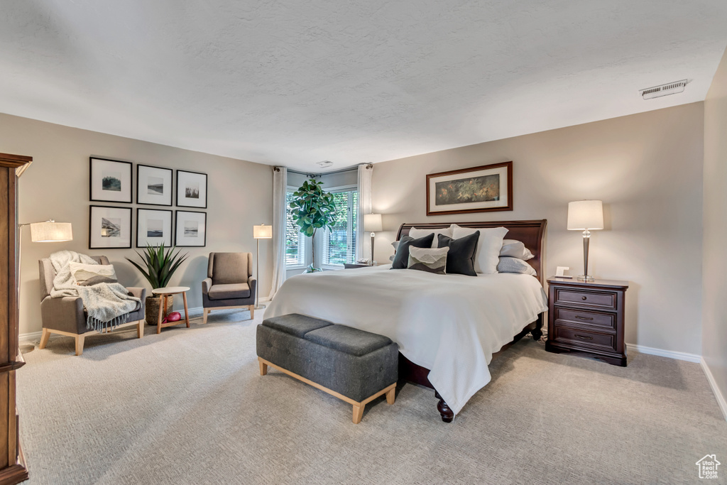 Bedroom with carpet floors and a textured ceiling