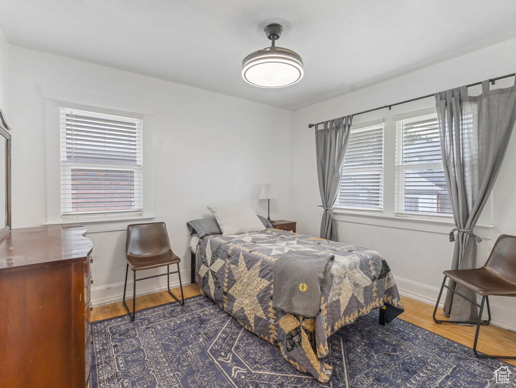 Bedroom featuring wood finished floors and baseboards