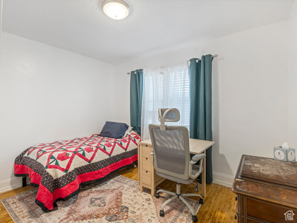 Bedroom with light wood finished floors and baseboards