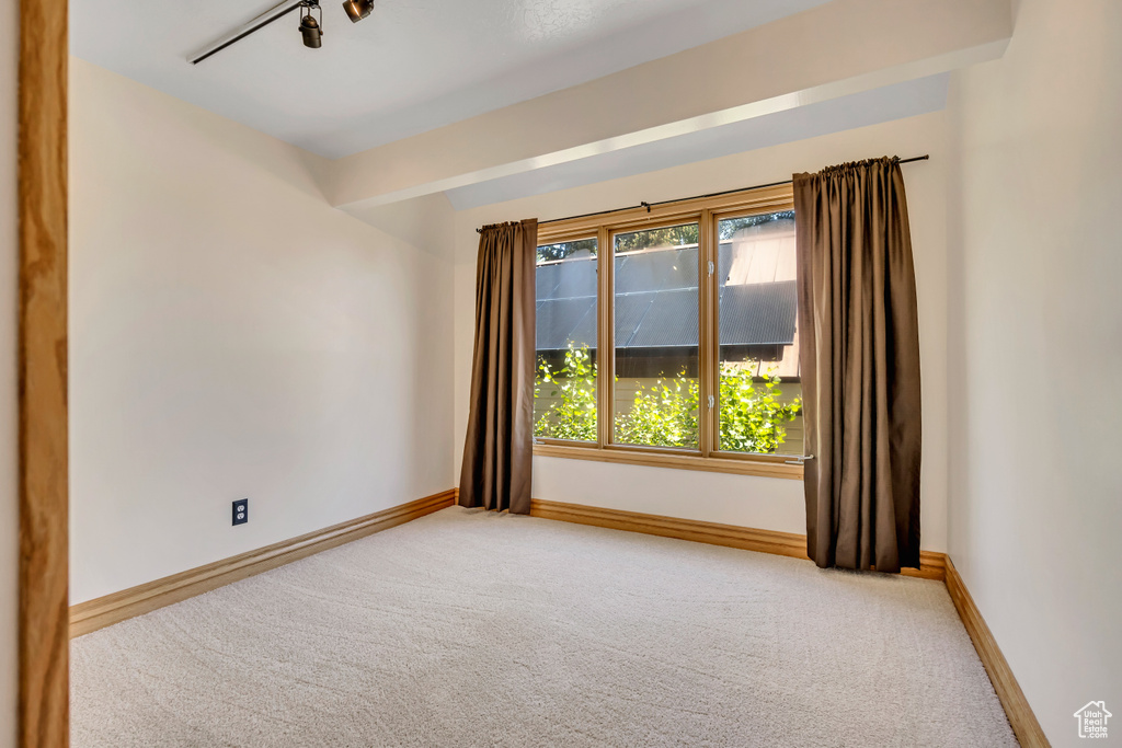 Unfurnished room featuring carpet floors and baseboards