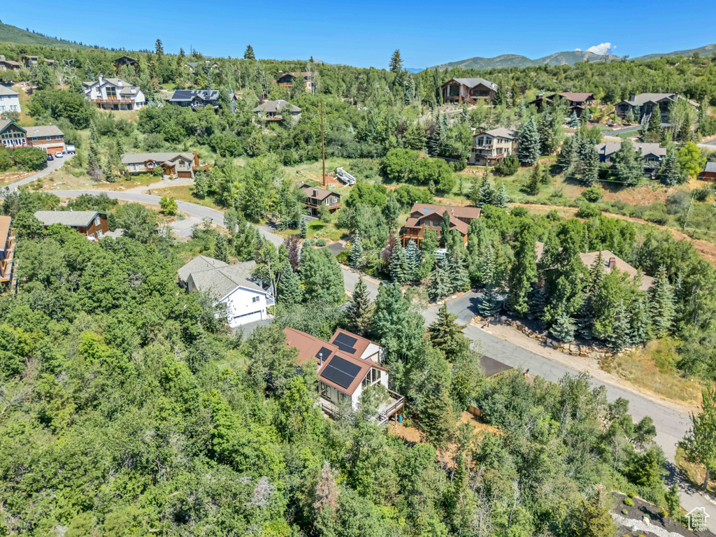 Aerial view of property\'s location featuring nearby suburban area and a mountain backdrop