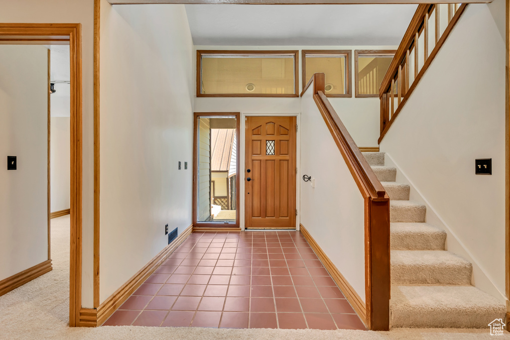 Tiled foyer entrance featuring stairway