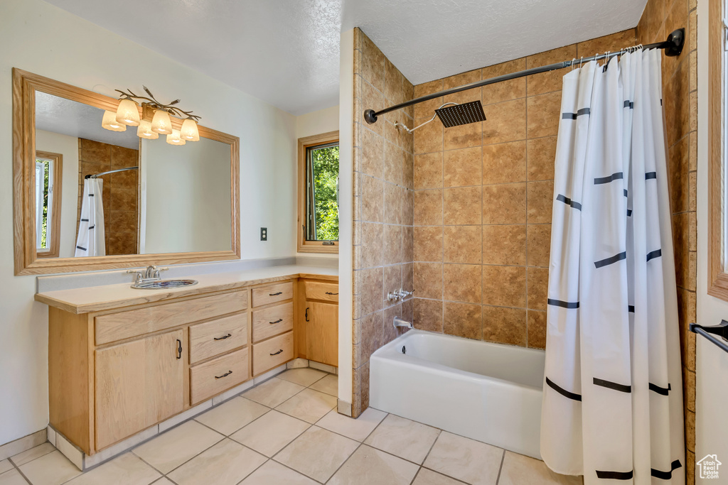 Full bath featuring shower / tub combo, vanity, and tile patterned flooring