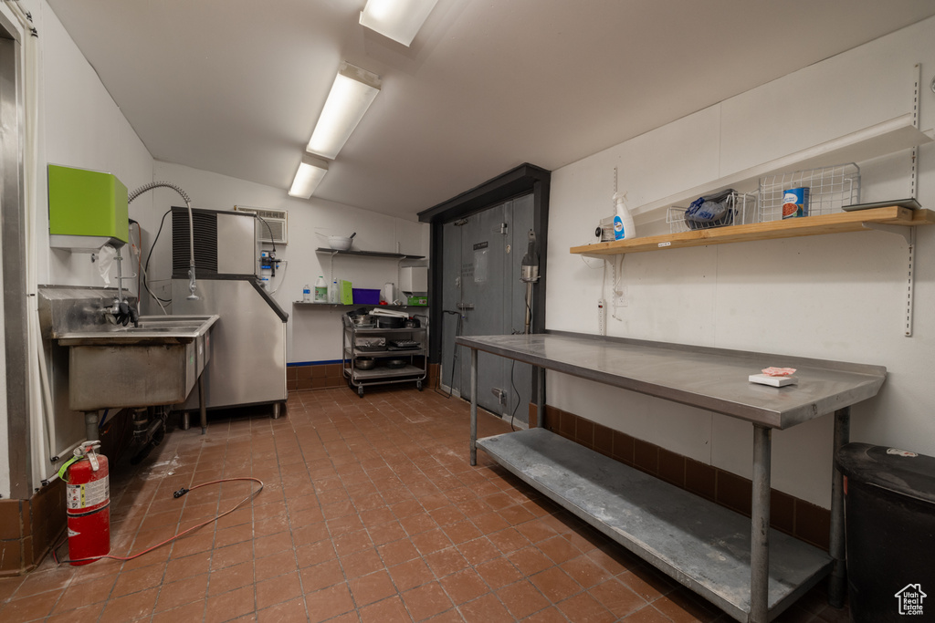 Basement with refrigerator and tile patterned flooring