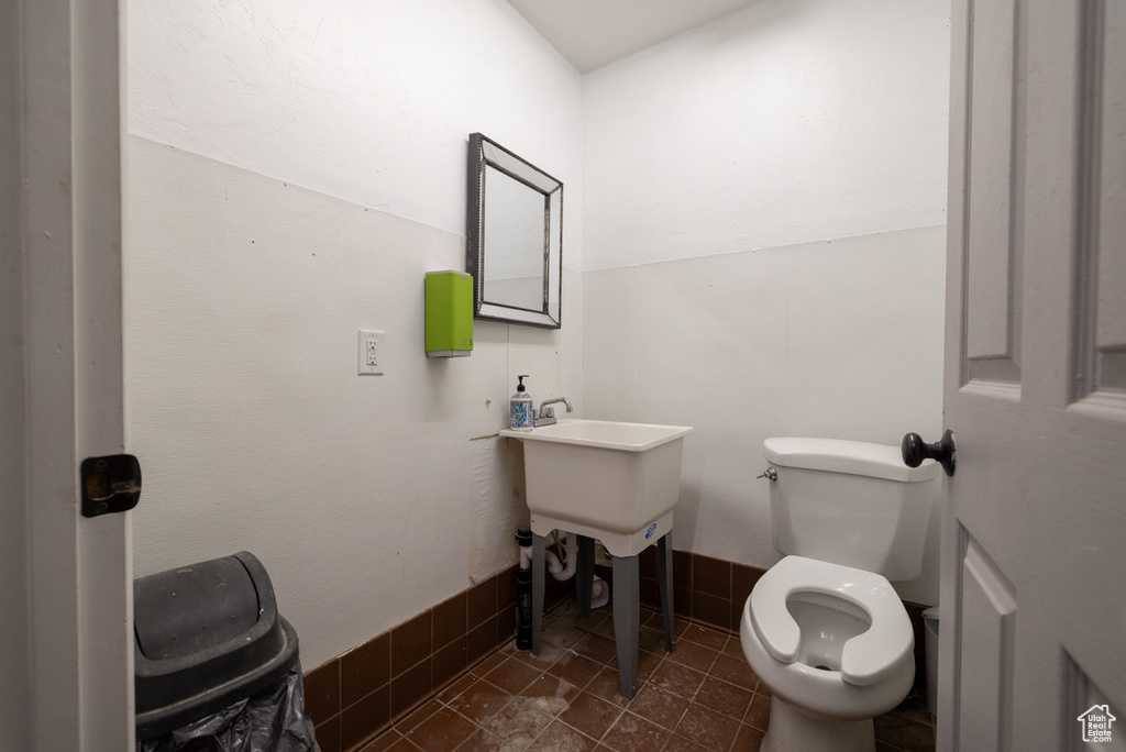 Half bathroom featuring toilet and tile patterned floors