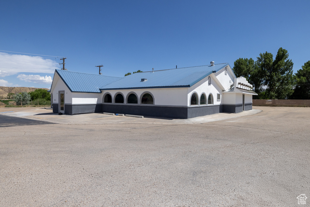 View of property exterior featuring a metal roof