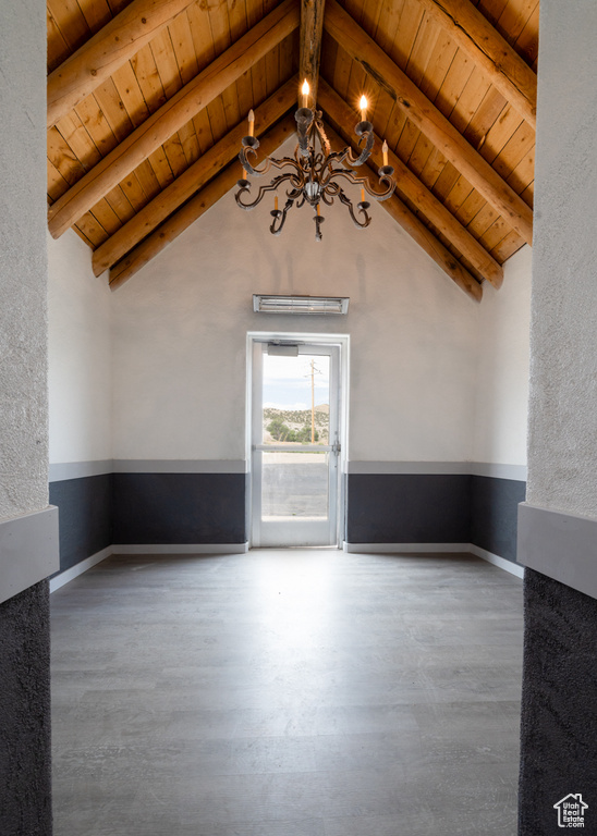 Unfurnished living room featuring a chandelier, wood ceiling, and wood finished floors