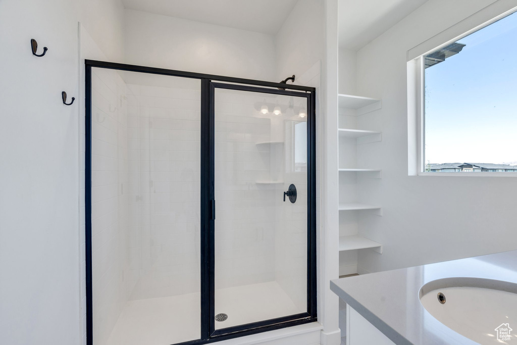 Bathroom with a shower stall and vanity
