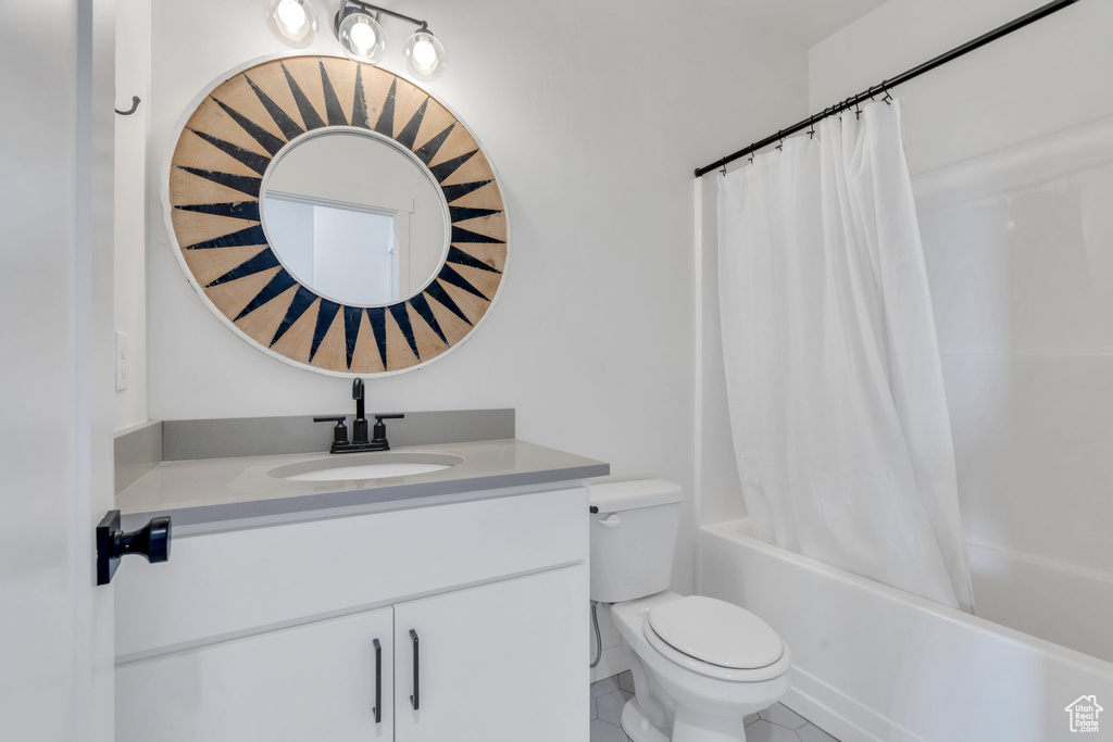 Full bath with vanity, shower / bath combination with curtain, and tile patterned floors