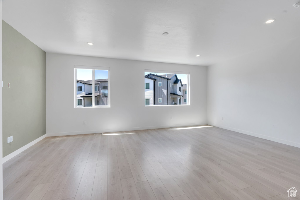 Empty room featuring light wood-style floors and recessed lighting