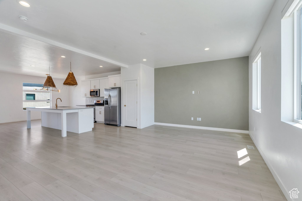 Unfurnished living room with light wood-style flooring and recessed lighting