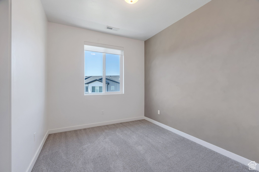 Empty room featuring carpet floors and baseboards