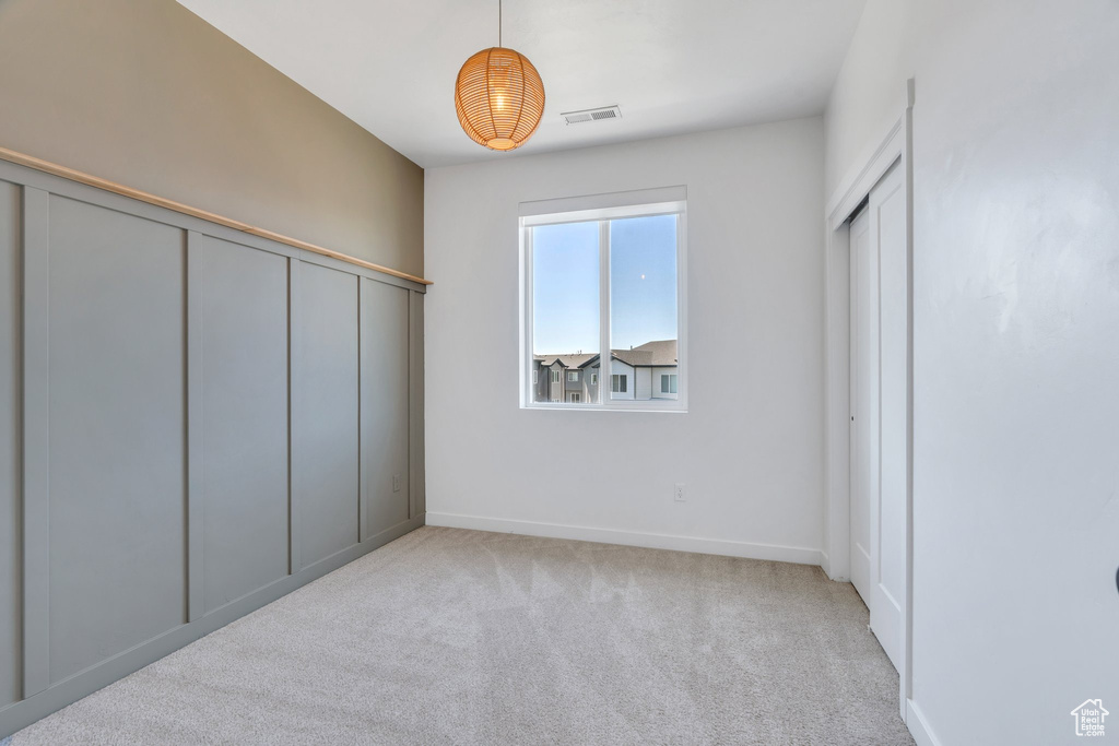 Unfurnished bedroom with carpet floors and baseboards