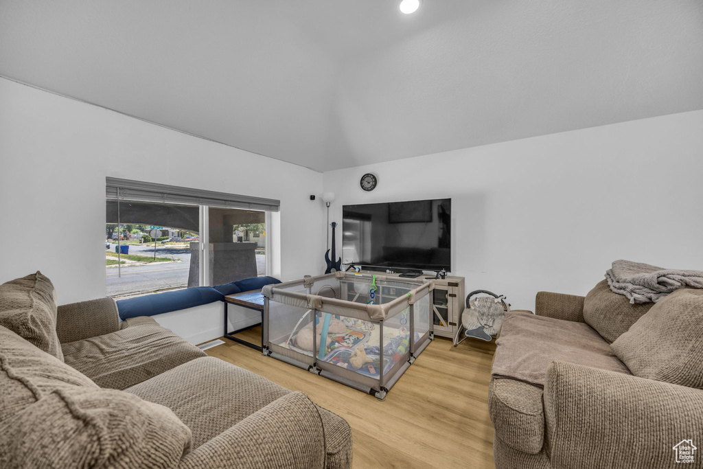 Living room with lofted ceiling and wood finished floors