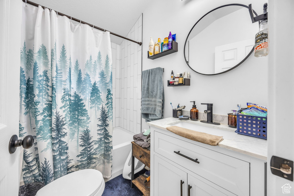 Bathroom featuring vanity and shower / bath combination with curtain