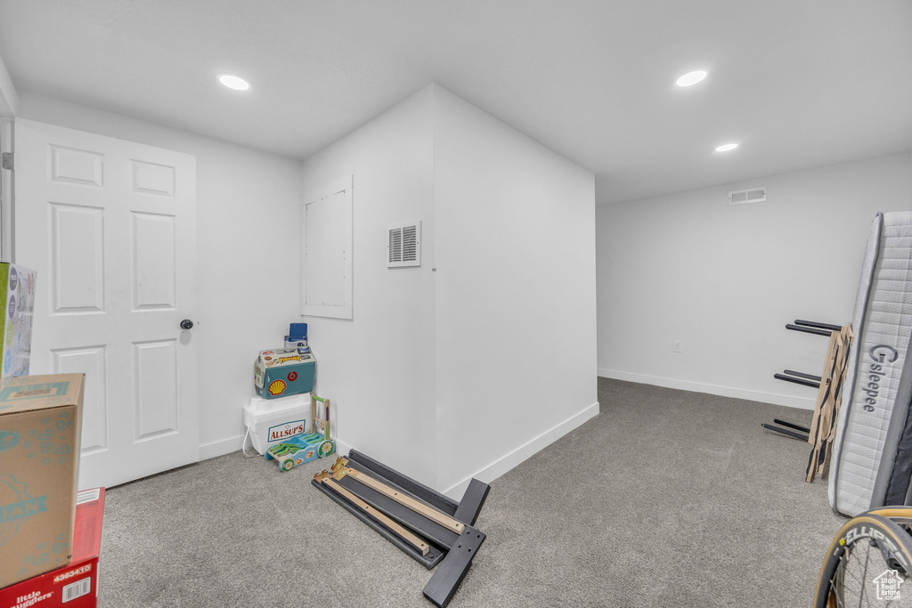 Exercise room with carpet flooring and recessed lighting