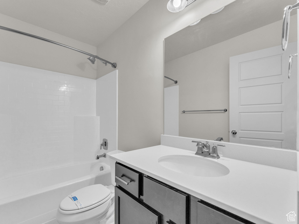 Bathroom featuring vanity and  shower combination