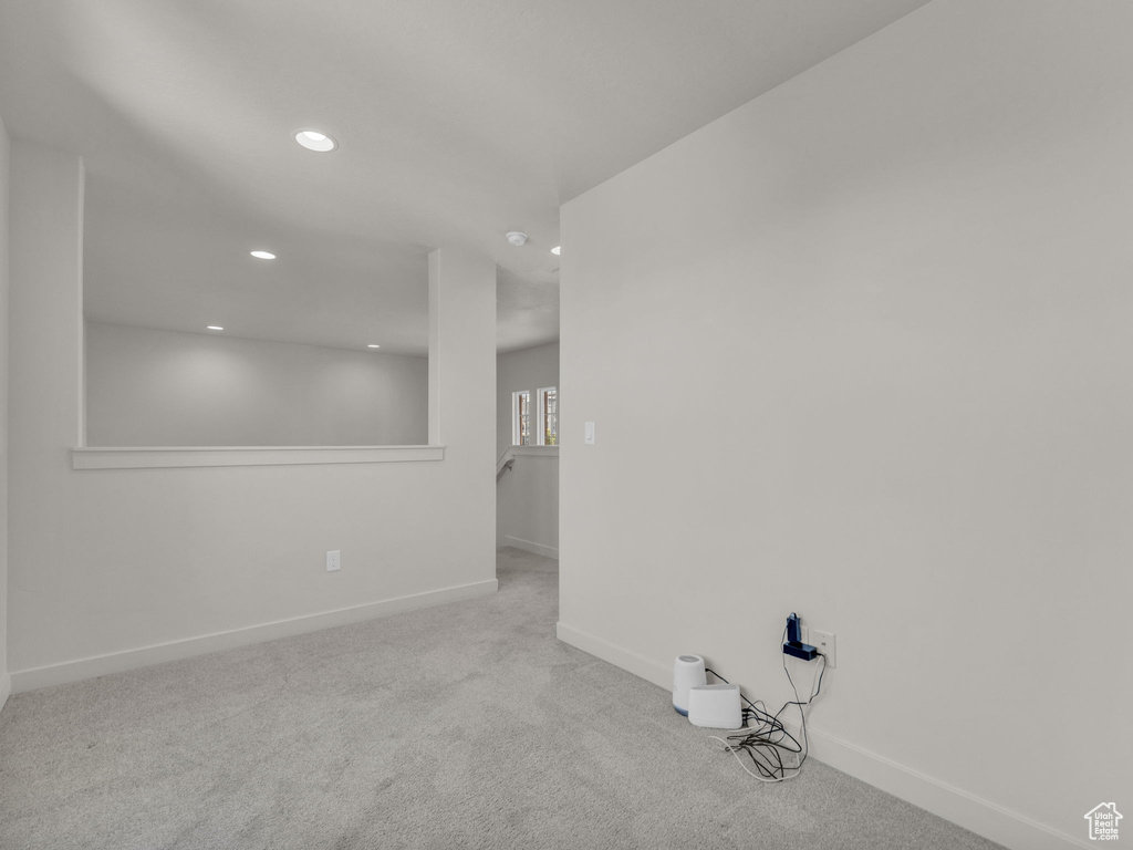 Empty room with recessed lighting and carpet floors