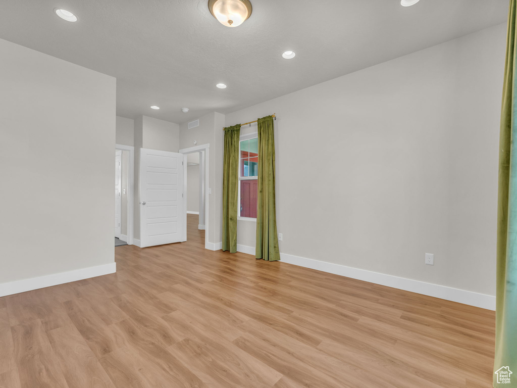 Unfurnished room with light wood-style flooring and recessed lighting
