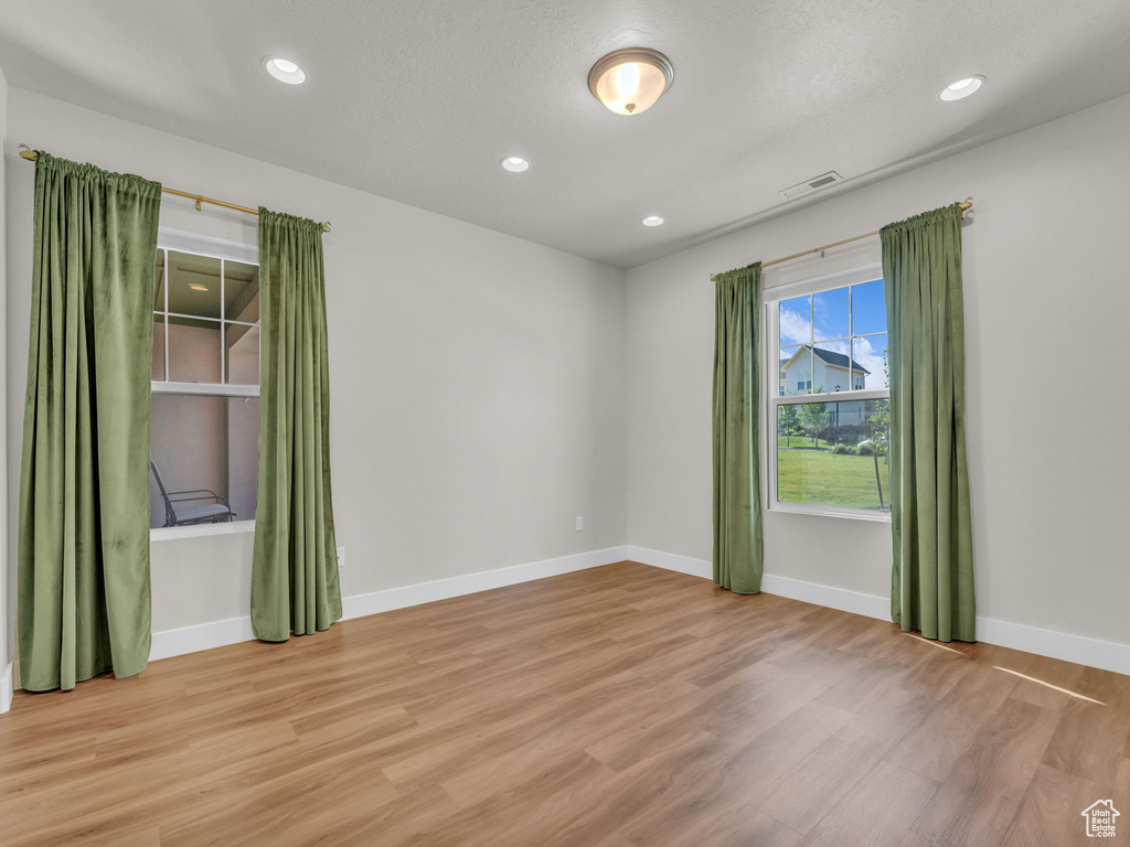 Unfurnished room with light wood-type flooring and recessed lighting