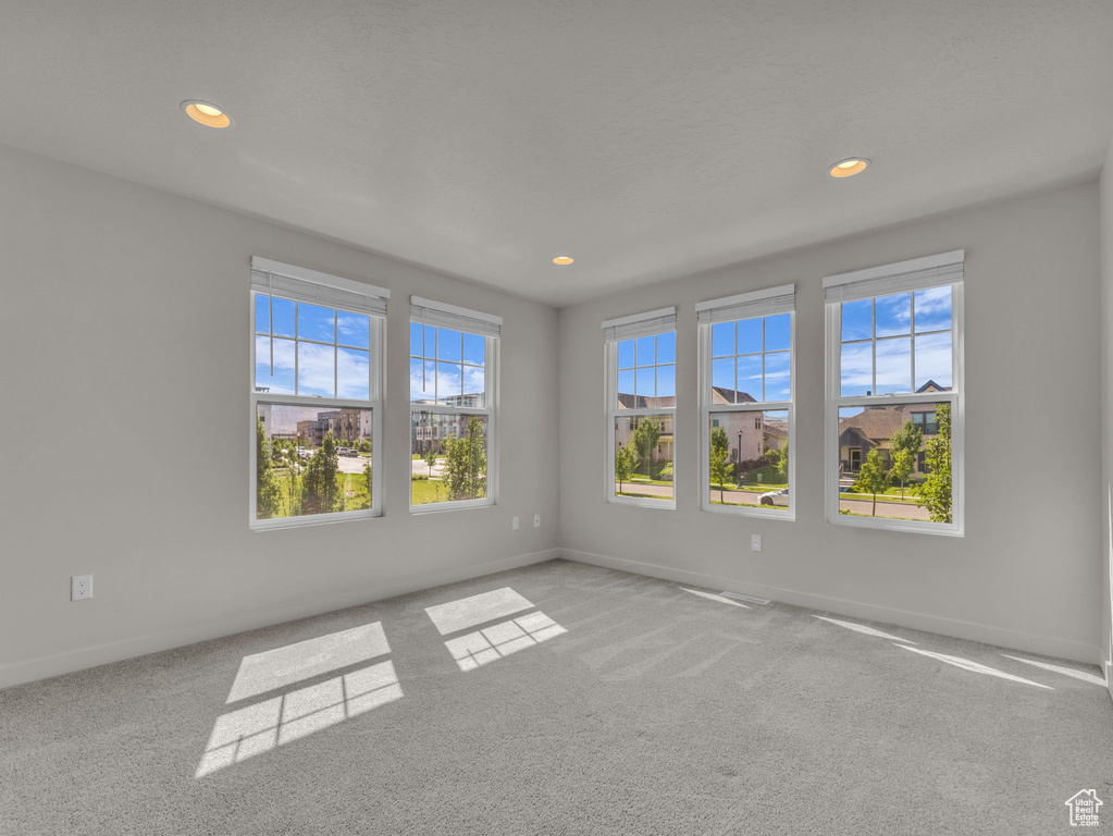 Spare room featuring recessed lighting and carpet