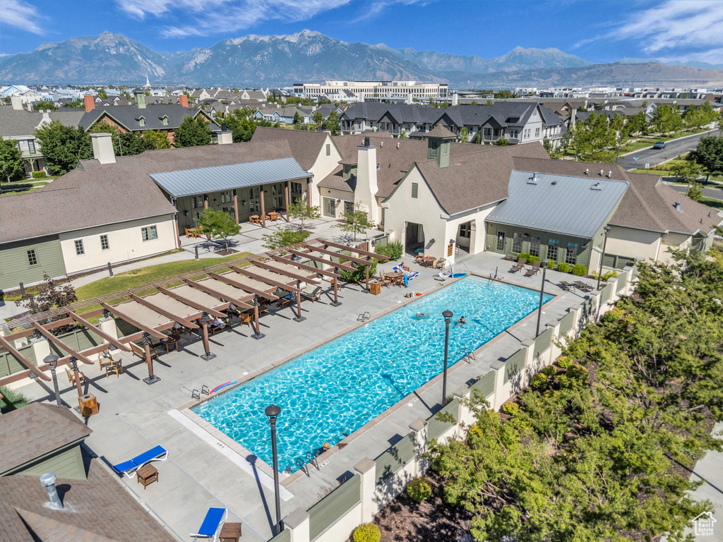 Community pool with a residential view, a patio area, and a mountain view