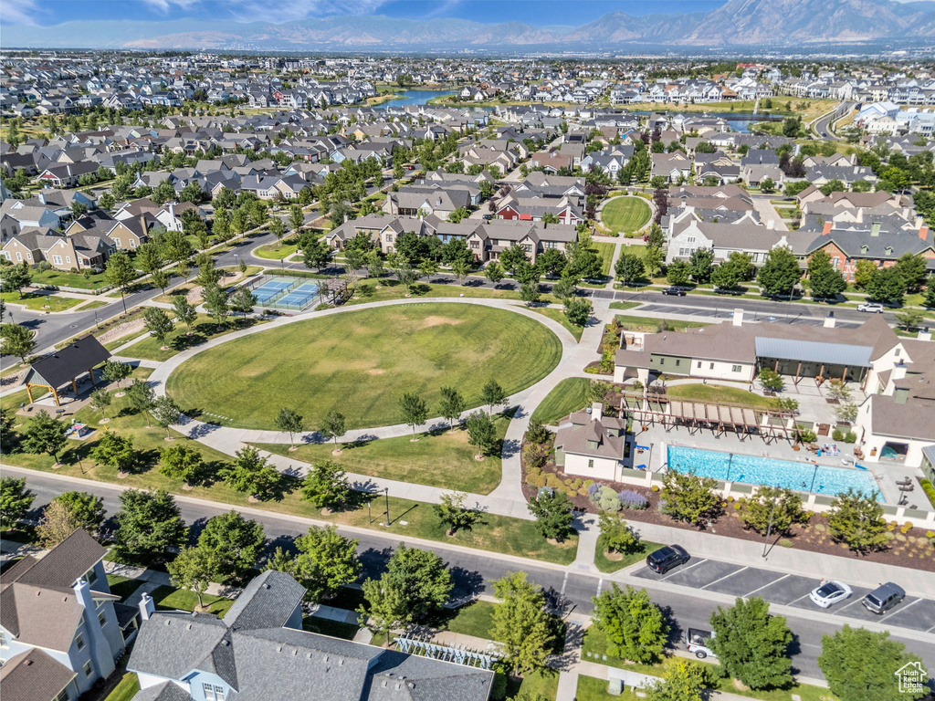 Aerial view of residential area featuring a pool area and a mountainous background