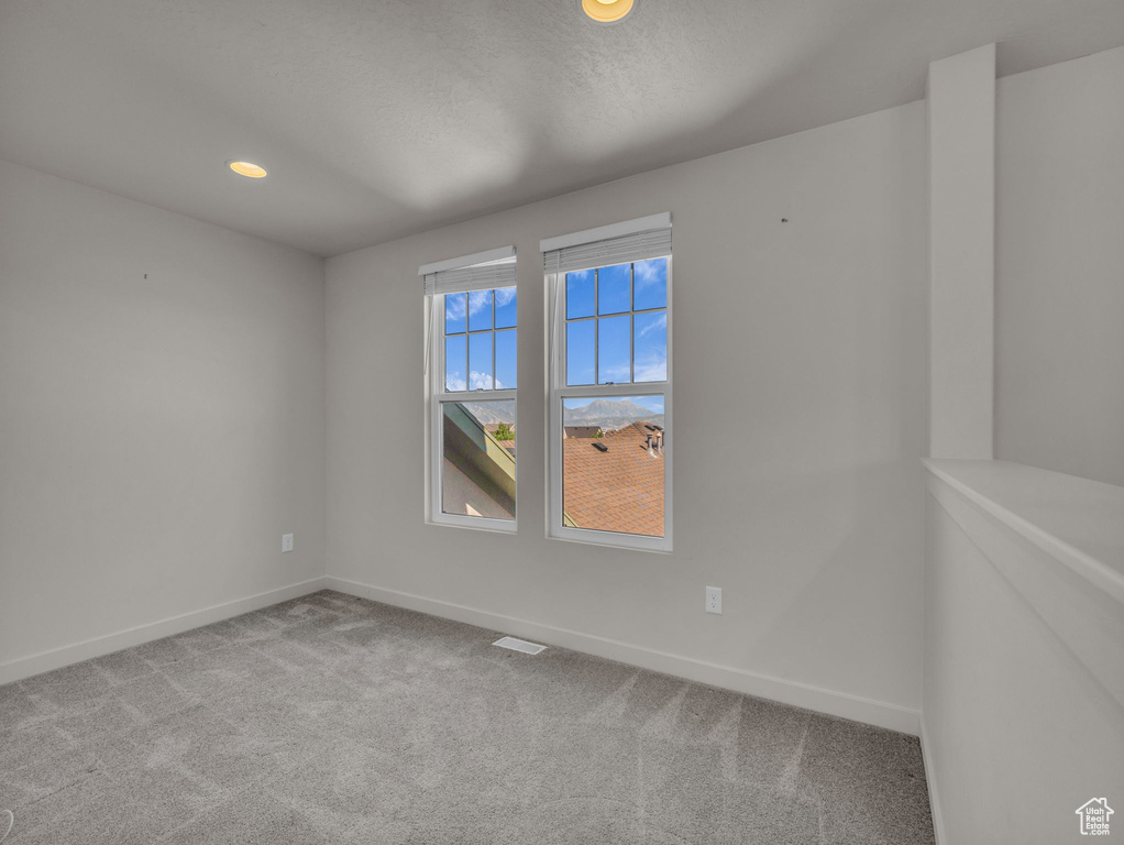Spare room with carpet floors and recessed lighting