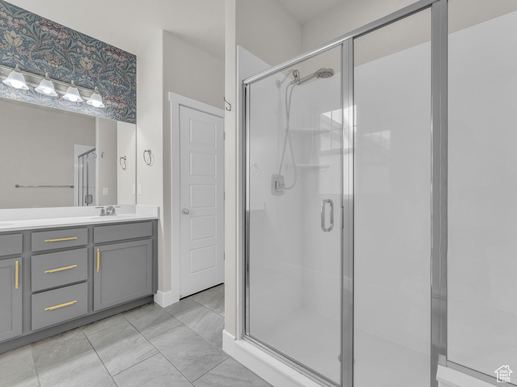 Full bathroom with a shower stall and vanity