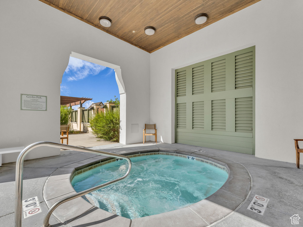 View of swimming pool with a community hot tub, a patio, and a pool