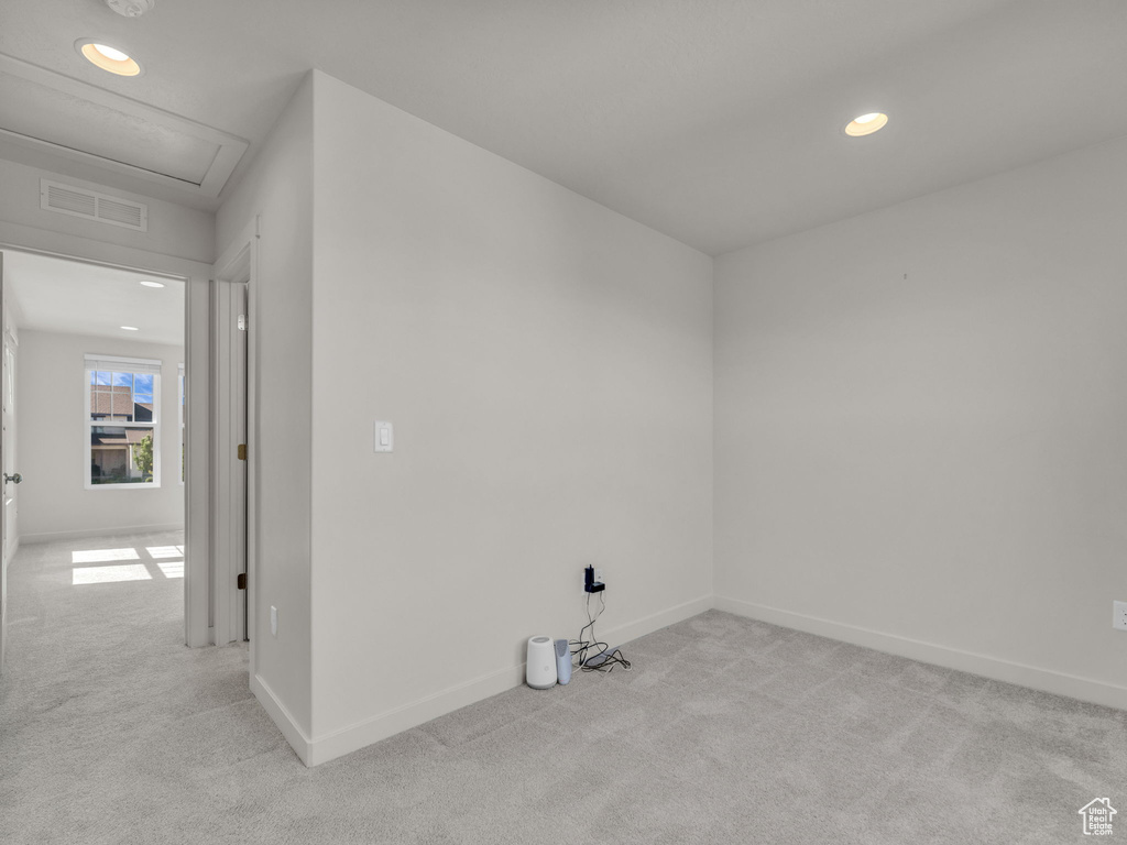 Unfurnished room featuring light carpet, recessed lighting, attic access, and a smoke detector