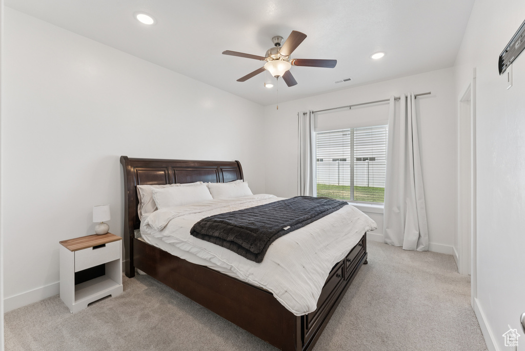 Bedroom with light colored carpet, recessed lighting, and ceiling fan