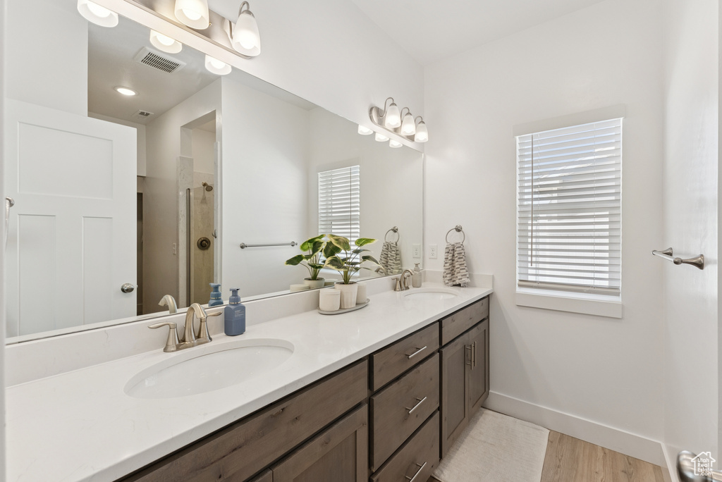 Bathroom featuring double vanity and a shower