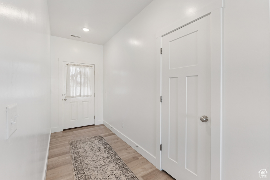 Entryway with light wood-style flooring and baseboards