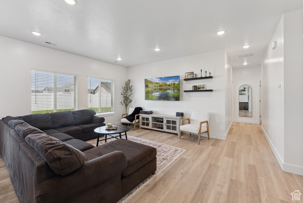 Living room featuring light wood finished floors and recessed lighting