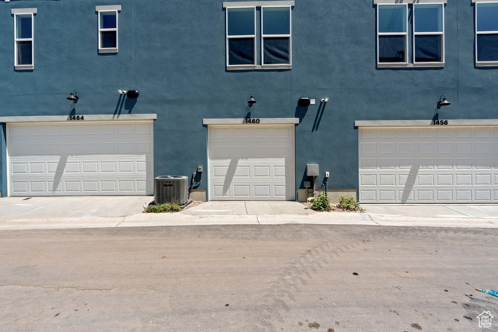 View of front of house featuring stucco siding and an attached garage