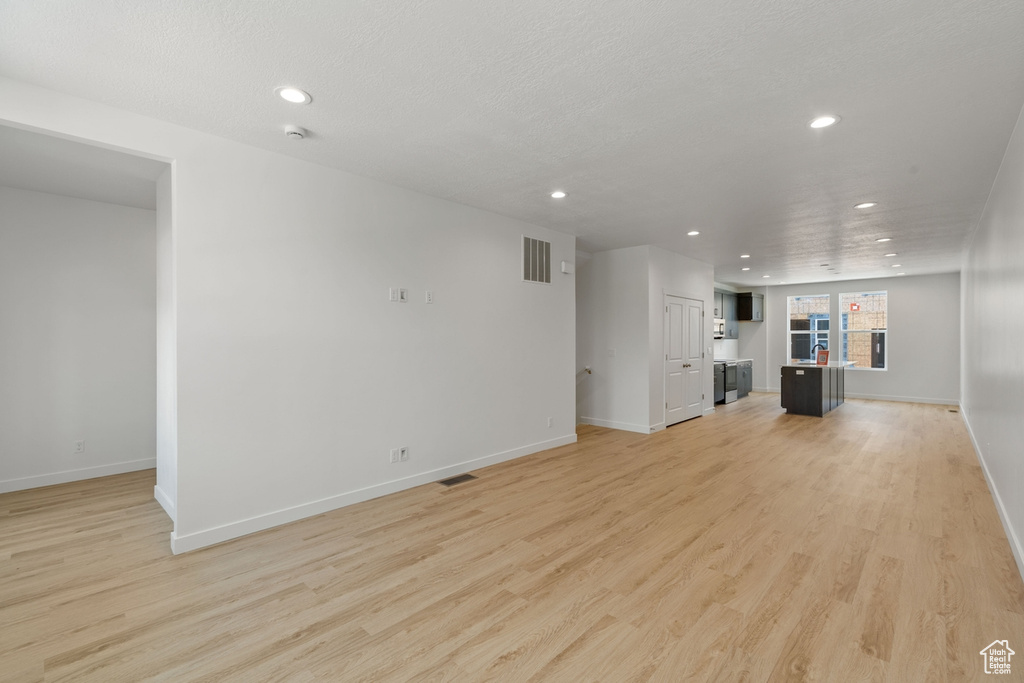 Unfurnished living room featuring recessed lighting and light wood finished floors