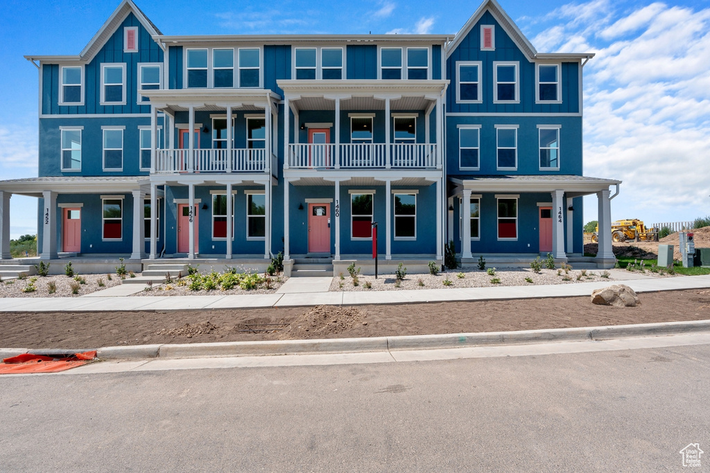 View of front of home featuring a balcony and a porch