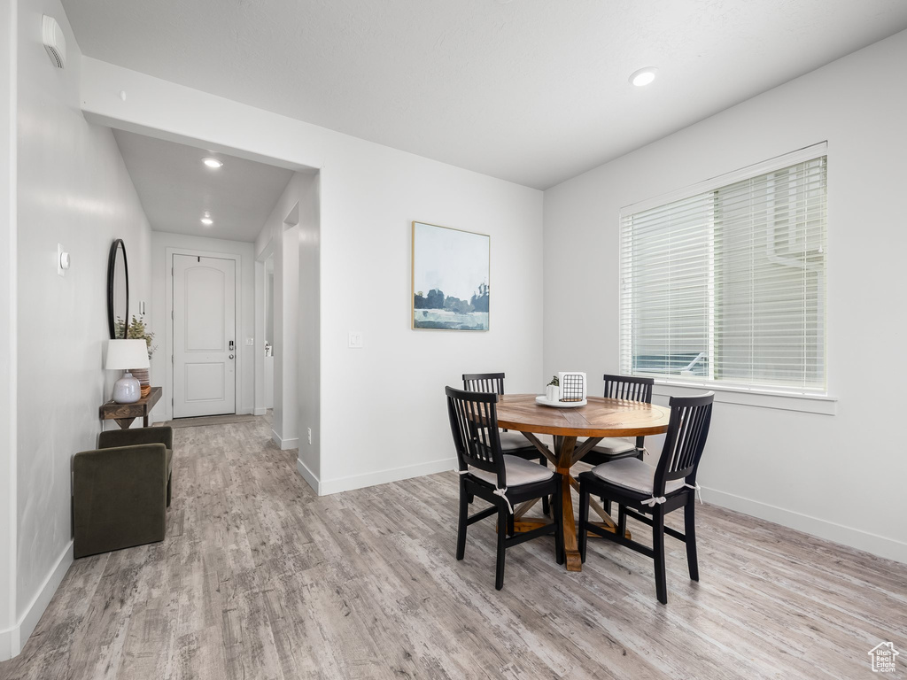 Dining space with light wood-style flooring and recessed lighting