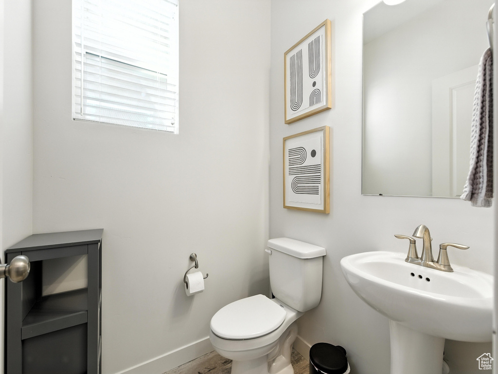 Bathroom with toilet and wood finished floors