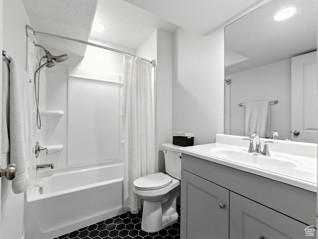 Bathroom featuring vanity and shower / bath combo
