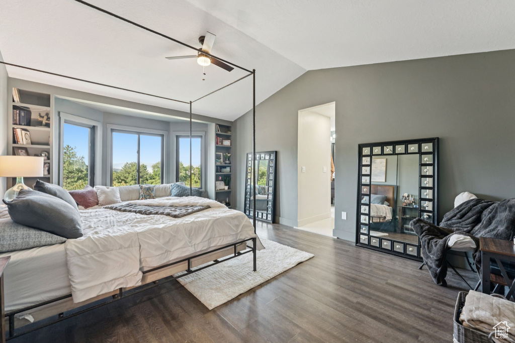 Bedroom with lofted ceiling, wood finished floors, and ceiling fan