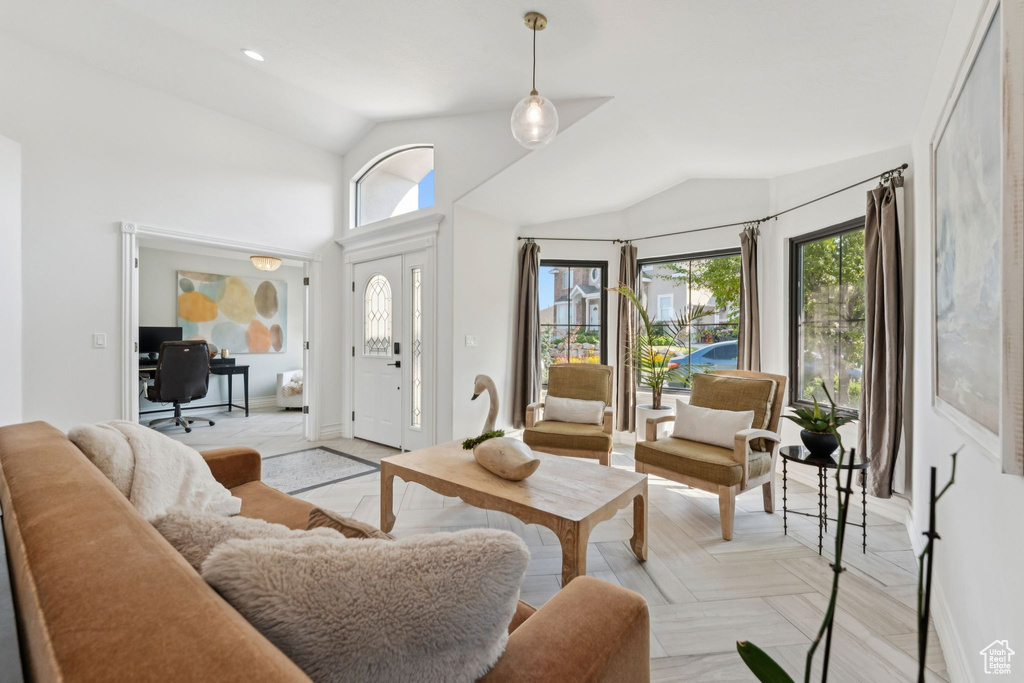 Living room featuring vaulted ceiling and an office area