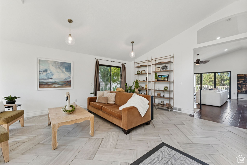 Living area with vaulted ceiling, plenty of natural light, ceiling fan, and recessed lighting