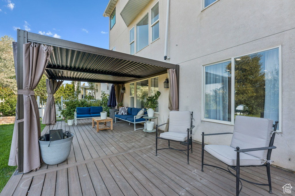 Wooden deck featuring outdoor lounge area