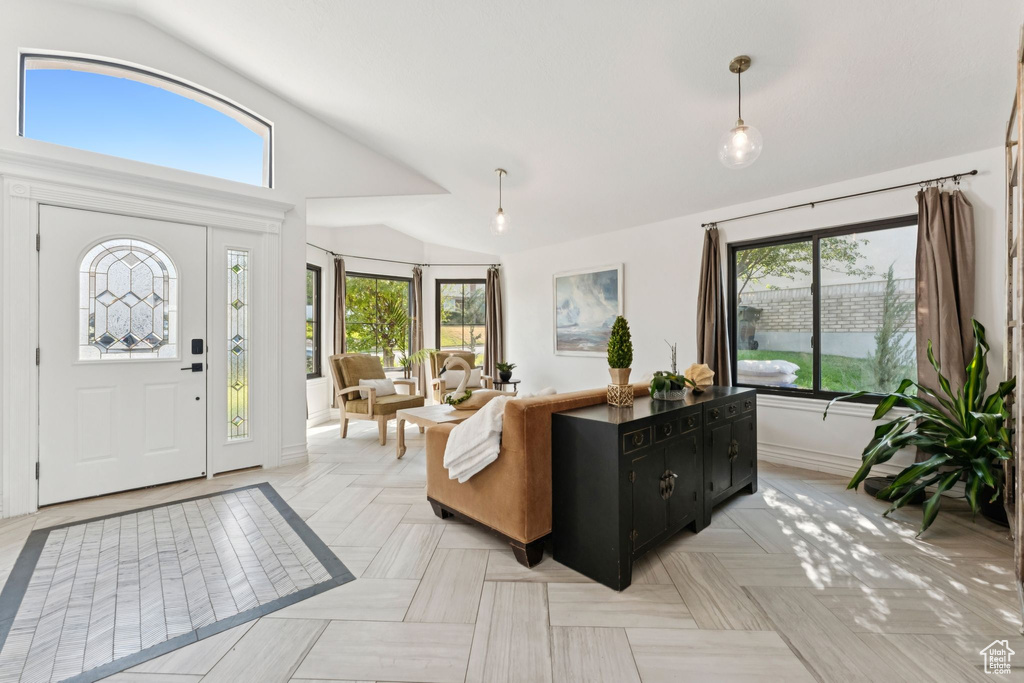 Foyer with vaulted ceiling and healthy amount of natural light