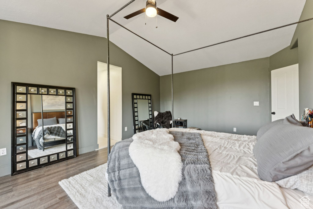 Bedroom with wood finished floors, lofted ceiling, and ceiling fan
