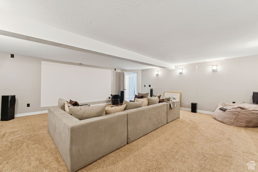 Living area featuring light carpet and baseboards
