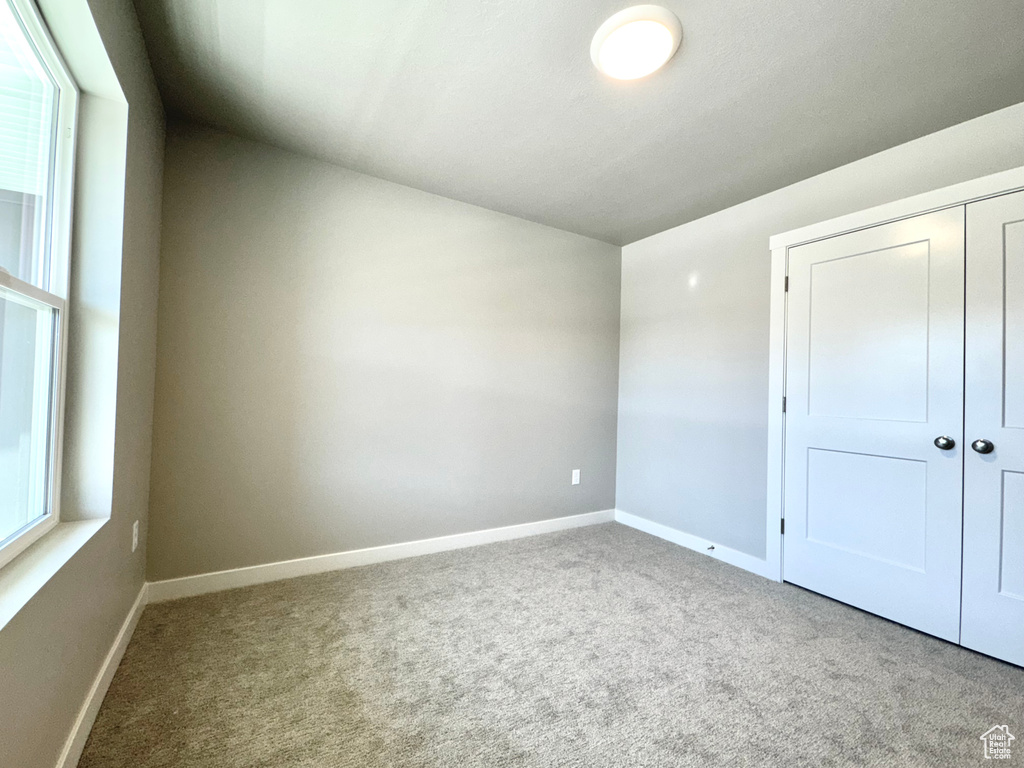 Unfurnished bedroom with carpet floors and a closet