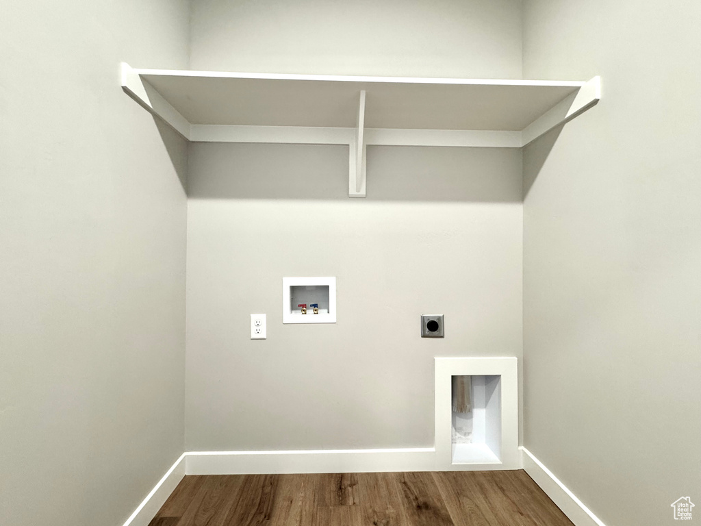 Laundry area with hookup for a washing machine, hookup for an electric dryer, and dark wood finished floors